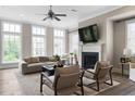 This welcoming living room features large windows and a cozy fireplace, creating a relaxing atmosphere at 6763 Encore Blvd, Atlanta, GA 30328