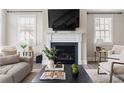 Bright living room is designed with a fireplace, large windows, and comfortable seating at 6763 Encore Blvd, Atlanta, GA 30328