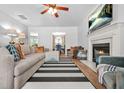 Inviting living room with a fireplace, mounted TV, ceiling fan, and comfortable seating at 1326 Castleberry Dr, Buford, GA 30518