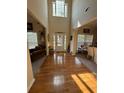 Bright foyer with hardwood floors, high ceilings, and natural light streaming through the front door at 4305 Evans Farms Dr, Cumming, GA 30040
