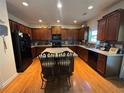 Well-equipped kitchen featuring an island with seating, dark cabinets, and stainless steel appliances at 4305 Evans Farms Dr, Cumming, GA 30040