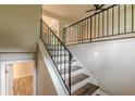 Modern staircase with dark wood treads and black metal railing, leading to an open upper level at 5312 Brittany Trl, Atlanta, GA 30349