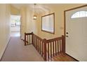 Inviting entryway featuring hardwood floors, a staircase, and a view of the kitchen at 999 Wiley Bridge Rd, Woodstock, GA 30188