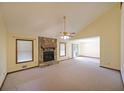 Bright living room with a stone fireplace, vaulted ceilings, and sliding glass doors at 999 Wiley Bridge Rd, Woodstock, GA 30188