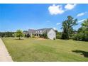 Lovely residence boasting a sprawling front yard, mature trees, and a peaceful neighborhood setting at 122 Gingers Way, Mcdonough, GA 30252
