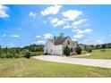 Spacious home with an attached two-car garage, a long driveway, and a well-maintained lawn at 122 Gingers Way, Mcdonough, GA 30252