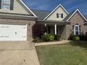 Charming one-story home with brick accents, lush landscaping, and a well-manicured lawn at 21 Spring Folly Nw, Cartersville, GA 30121