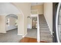 Inviting foyer with hardwood floors, staircase, and arched doorways at 40 Wimberly Way, Covington, GA 30016