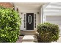 Elegant front door with sidelights, framed by lush, well-maintained landscaping at 40 Wimberly Way, Covington, GA 30016