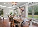 Inviting dining room with hardwood floors, natural light, and seating for six at 161 Archstone Sq, Mcdonough, GA 30253