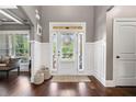 Bright foyer with hardwood floors, white wainscoting, and a front door with sidelights at 161 Archstone Sq, Mcdonough, GA 30253