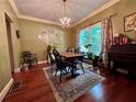 Elegant dining room featuring a chandelier, wood floors, and a cozy atmosphere at 260 Manning Sw Rd # 42, Marietta, GA 30064