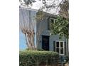 Charming home exterior showcases light blue siding and black shutters on a tree-lined street at 260 Manning Sw Rd # 42, Marietta, GA 30064