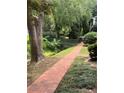 Scenic brick path leading through lush greenery towards a charming bridge, creating a serene outdoor setting at 260 Manning Sw Rd # 42, Marietta, GA 30064