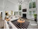 Bright, open living space with high ceilings, fireplace and large windows at 4345 Park Brooke Trce, Alpharetta, GA 30022