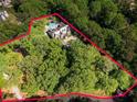 Expansive aerial view of a home surrounded by lush forest, highlighting its secluded location and private pool at 4375 Mount Paran Pkwy Nw, Atlanta, GA 30327