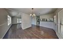 Dining room with hardwood floors, elegant chandelier, and abundant natural light at 516 N Shore Rd, Lithonia, GA 30058