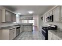 Well-lit kitchen with granite counters, stainless steel appliances, and ample cabinet space at 516 N Shore Rd, Lithonia, GA 30058