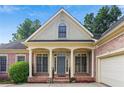 Charming brick home featuring a covered front entrance with stately columns and a well-manicured lawn at 980 Ector Chase Nw, Kennesaw, GA 30152