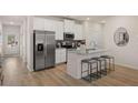 Kitchen with stainless appliances, white cabinets, granite countertops, and an island with seating at 1122 Edinberg Dr, Villa Rica, GA 30180