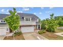 Beautifully landscaped two-story home with gray siding, brick accents, and lush green lawn at 4591 Grenadine Cir, Acworth, GA 30101