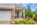 Inviting front porch with a charming entryway, brick accents, and well-maintained landscaping at 4591 Grenadine Cir, Acworth, GA 30101