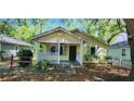 Charming cottage-style home with a covered porch and lush, mature landscaping at 1162 Sims St, Atlanta, GA 30310