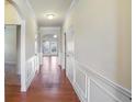 Bright hallway with hardwood floors and detailed wainscoting at 1790 Piedmont Ln, Cumming, GA 30040