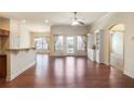 Open living room with hardwood floors, built-in shelving, and a view to the back yard at 1790 Piedmont Ln, Cumming, GA 30040