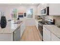 Modern kitchen with white cabinets, stainless steel appliances and granite countertops provide a stylish and functional space at 3064 Steinbeck Way, Atlanta, GA 30344