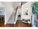 Elegant foyer with hardwood floors, staircase with iron spindles, and an open view into adjacent rooms at 596 Deadwood Trl, Locust Grove, GA 30248
