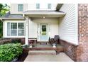 Inviting front porch with charming blue door, decorative plants, and brick accents at 596 Deadwood Trl, Locust Grove, GA 30248