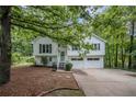 Charming two-story home featuring a well-manicured yard and a welcoming front entrance with a two-car garage at 115 Jamie Dr, Hiram, GA 30141