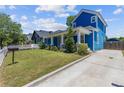 Charming two-story home with a blue exterior, landscaped yard and inviting front porch at 1598 Jonesboro Se Rd, Atlanta, GA 30315