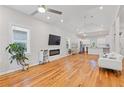 Bright living room with hardwood floors, a vaulted ceiling, and a modern electric fireplace at 1598 Jonesboro Se Rd, Atlanta, GA 30315