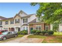 Inviting townhome showcasing stone accents, lush landscaping, and a private driveway at 1785 Fielding Way, Hampton, GA 30228