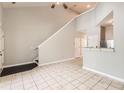 Open concept living room featuring tile floors, staircase, and a convenient breakfast bar to the kitchen at 1785 Fielding Way, Hampton, GA 30228