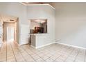 Bright living room with tile flooring, high ceilings, and a breakfast bar overlooking the kitchen at 1785 Fielding Way, Hampton, GA 30228