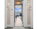 Hallway view into a modern, open-concept living space with floor-to-ceiling windows and stylish furnishings at 3630 Peachtree Rd # 1909, Atlanta, GA 30326
