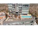 Upscale rooftop amenity deck featuring a swimming pool, lounge seating, grilling area, and green space for relaxation at 3630 Peachtree Rd # 1909, Atlanta, GA 30326