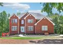 Charming two-story brick home with manicured lawn, walkway and landscaping at 1424 Brighton, Loganville, GA 30052