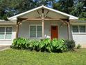Close up of front porch with orange door and decorative plants at 1909 Cindy Dr, Decatur, GA 30032