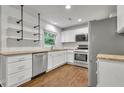 Modern kitchen features stainless steel appliances, white cabinets, and open shelving at 1909 Cindy Dr, Decatur, GA 30032