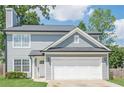 Close up of a charming two-story home with attached garage, showing architectural details at 2055 Summer View Place Sw, Marietta, GA 30060