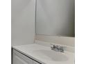 Updated bathroom featuring a white sink vanity with chrome faucet and a large mirror at 5634 Windwood Rd, Atlanta, GA 30349