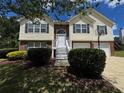 Charming home featuring a brick accent, well-maintained landscaping, and inviting front steps to the entryway at 851 Walkingstick Dr, Douglasville, GA 30134