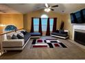 Cozy living room showcasing a fireplace, plush seating, vaulted ceiling, and a unique area rug at 851 Walkingstick Dr, Douglasville, GA 30134