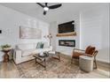 Bright living room featuring a modern ceiling fan, decorative fireplace and stylish furniture at 231 Ivey Ter, Temple, GA 30179
