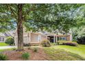 Beautiful home with manicured lawn and mature trees providing ample shade at 4445 Vanadium Bend, Cumming, GA 30040