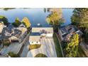 Stunning aerial view of a waterfront property with lush landscaping, a long driveway, and scenic lake views at 9058 Woodlake Lane, Villa Rica, GA 30180